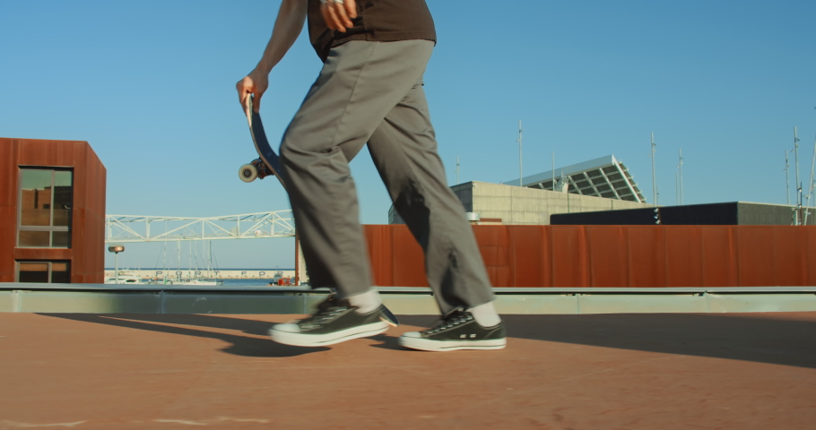 Side shot of cool modern millennial young man perform various tricks on skateboard in urban city surroundings. User generated content on action camera. Skateboard lifestyle and tricks Royalty-Free Stock Footage #1062831001