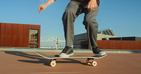 Side shot of cool modern millennial young man perform various tricks on skateboard in urban city surroundings. User generated content on action camera. Skateboard lifestyle and tricks