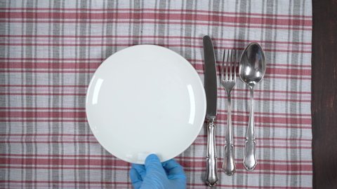 Empty white plate with napkin, and cutlery. Abstract food background.