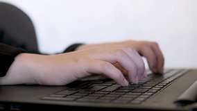 Woman hands typing on the laptop keyboard for working and learning