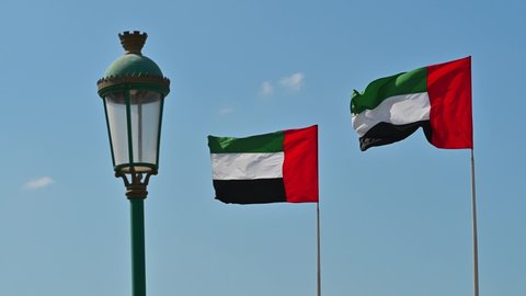 4k Footage: Two National Flags of United Arab Emirates (UAE) Waving in Wind against Clear Blue Sky, A Part UAE National Day Celebrations.