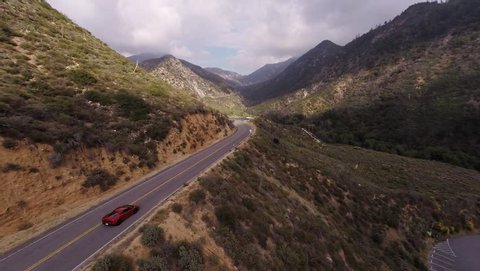 Extreme ride on the red Lamborghini Gallardo at Angeles Crest Hwy. Shooting from a helicopter.