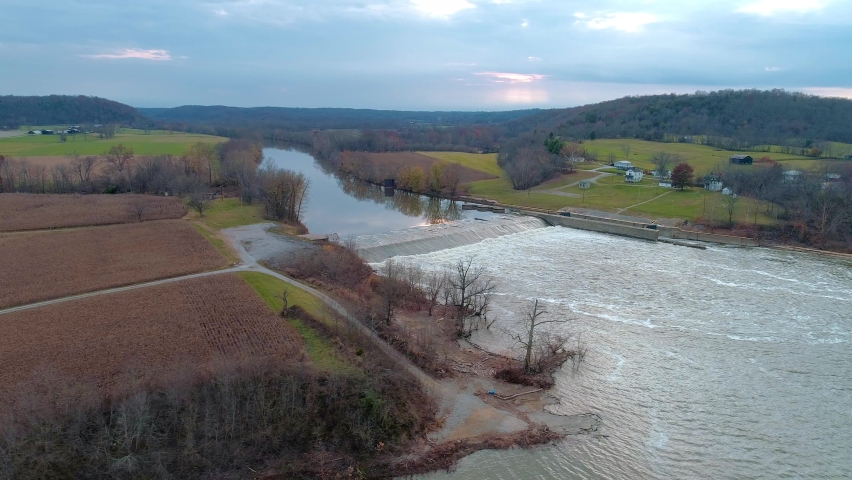 Aerial dolly shot to right of Kentucky river lock and dam number 3 in Monterey Kentucky in the fall at sunset