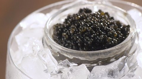 Black Caviar rotated background.Texture of expensive luxury caviar in tin can 