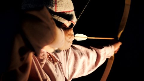 Archery at a distant target. The arrow hits the target. Lots of arrows hit the targets. The arrow hits the target. Accurate archer shooting. Accuracy competition. A male archer shoots a bow. 