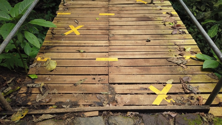 Walking Through Bridge in Forest With Social Distancing Sign - PoV