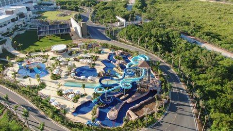 Aerial view of tropical resort with adventure waterpark, aquapark, water slides and swimming pool area, family fun in vacation, Punta Cana in Dominican Republic, all inclusive travel and leisure