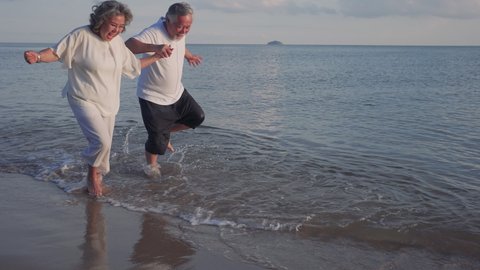 Happiness Asian couple senior elderly retirement resting and running at sunset beach honeymoon family together people lifestyle, Slow motion footage
