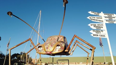 Coober Pedy, South Australia, Australia - Aug 27, 2019: Opal Bug car of Coober Pedy opal jewelry shop with a beetle sculpture. Opal mining capital of Australia.
