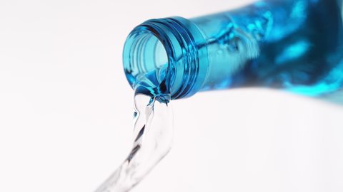 Pouring Mineral Water from a Blue Glass Bottle on the White Background in 1000fps (Phantom Flex)