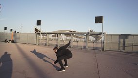 Athletic young man in black clothes dancing contemporary in an urban environment and doing cartwheels while practicing acrobatic exercises outdoors in the city. - Powered by Shutterstock - Get 15% off with code: PIKWIZARD15