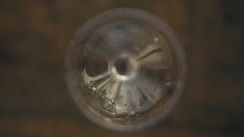 Pouring rose wine into a glass, top view