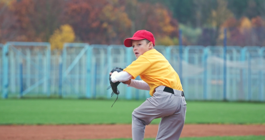 Baseball at school, the pitcher pitches fastball toward batter, young boy throwing the ball, 4k slow motion.