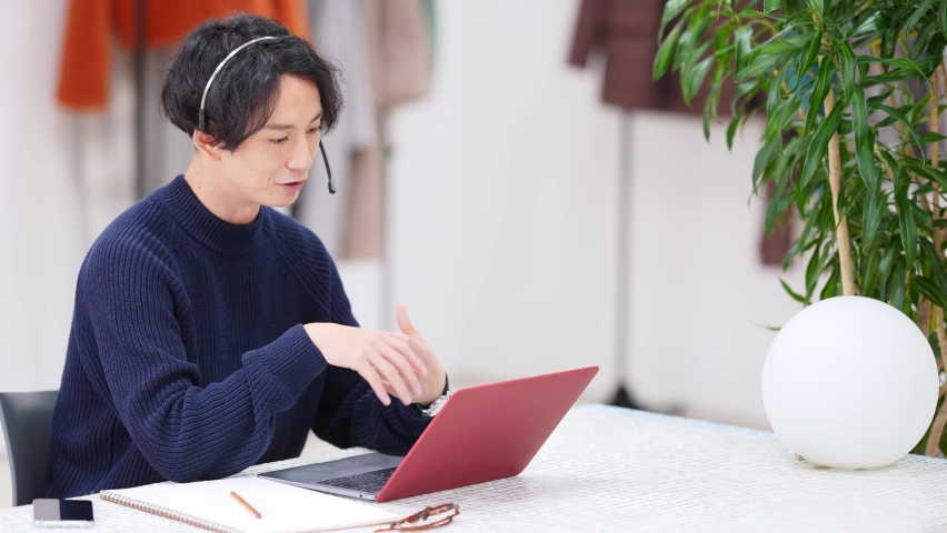 Young asian man talking in video conference.