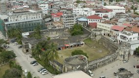 
Aerial view Zanzibar Tanzania. Drone video of an old fortress with high walls standing in the center of Stone Town near historic buildings and streets with beautiful scenery.