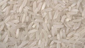 Rotation of grains of rice are close-up. Rice porridge. Long-grain rice.