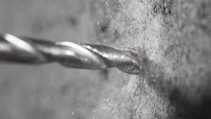 Super slow motion of detail of a drill bit drilling into concrete. Filmed on very high speed cinema camera, 1000 fps. Royalty-Free Stock Footage #1062888226