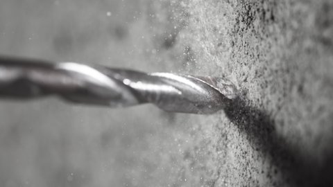 Super slow motion of detail of a drill bit drilling into concrete. Filmed on very high speed cinema camera, 1000 fps.