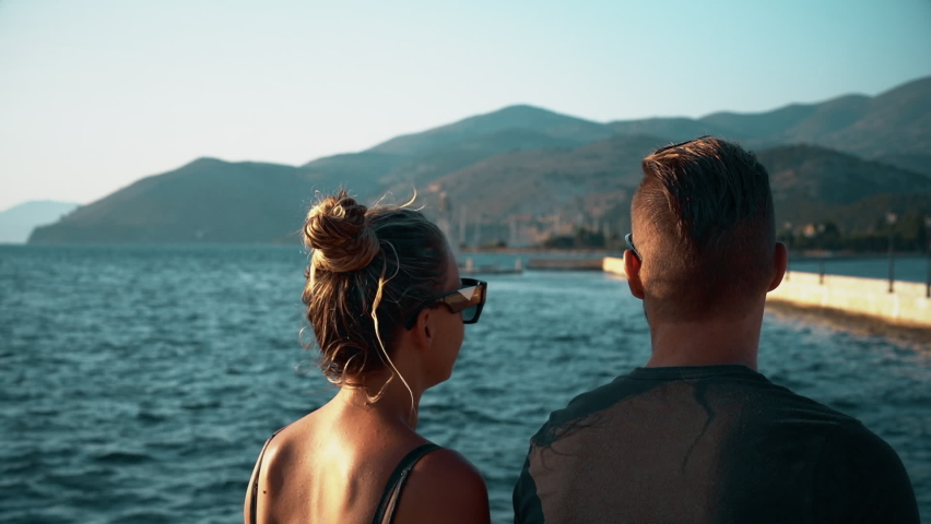 Young couple walking along a pedestrian bridge in the capital of Kefalonia, Argostoli