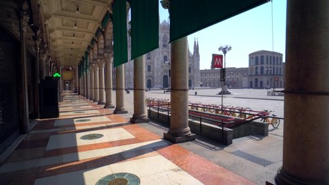 Milan, Italy - March, 2020: Pigeons are waiting for people on an empty square in front of the cathedral. Chinese Covid Crown Virus 19. Quarantine. Pandemic. City of the desert. Piazza Duomo