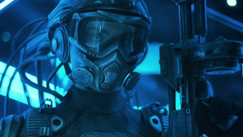 Portrait soldier of future in fiction helmet holding assault gun in her hand backlit with blue neon street lights. Female combat cyborg in futuristic protective costume. Cyberpunk warrior at night Stock Video