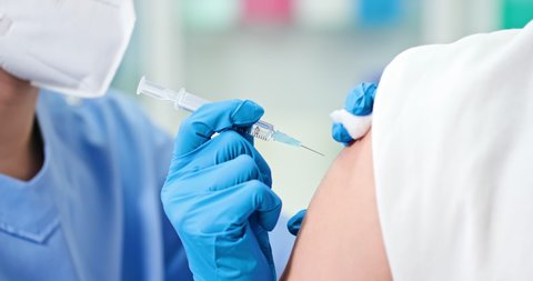 close up of asian doctor giving patient vaccine insulin or vaccination in hospital