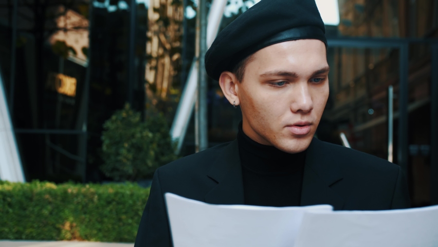 Caucasian Man working with business papers on the street.