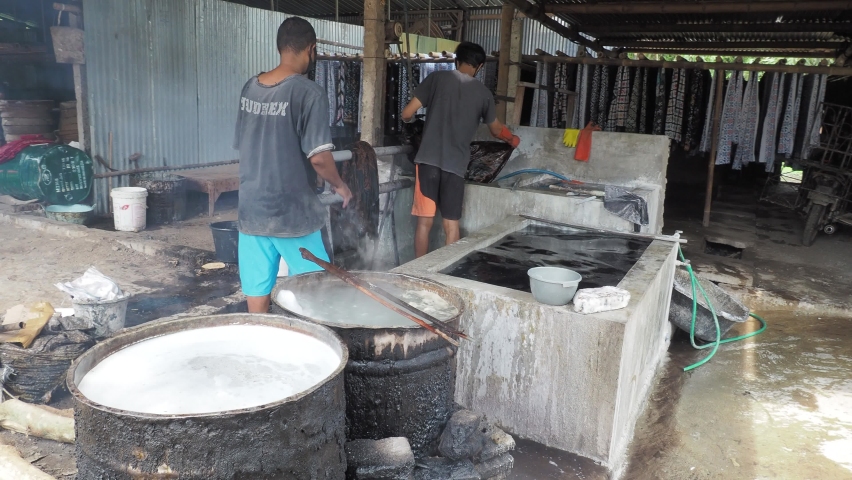 Nglorod batik process to dissolves the wax on the batik cloth by placing it  in boiling water: yogyakarta, indonesia - november 21, 2020