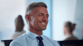 Closeup laughing businessman showing thumbs up at online video call. Positive male worker talking during video interview. Smiling business man gesturing hands. Surprised man waving head no