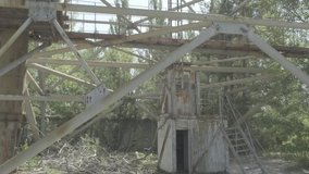 Fast tilt up the Duga-1 radar station in Chernobyl Ukraine. The structure is back lit by the sun. Ungraded Log Footage