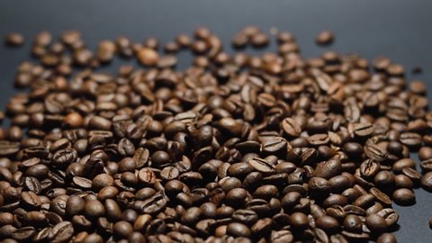 Coffee Beans on black background. Close-up dolly shot. 