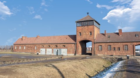 Time lapse of Auschwitz concentration camp in occupied Poland during World War II and the Holocaust. during a sunny cloudy day. There is the  train binary in close up