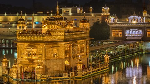 Night timelapse view of thousands of Sikh pilgrims visiting the Golden Temple aka Harmandir Sahib in Amritsar, Punjab, India. 