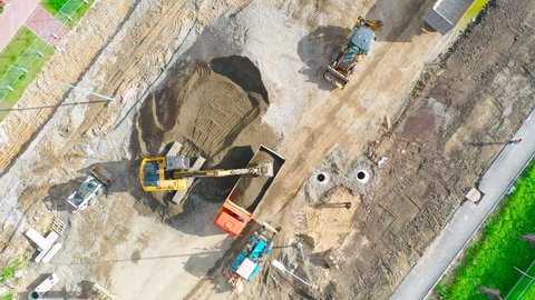 Construction of a city street, laying of communications, installation of sewer hatches, gutters, curbs. Preparation for paving, aerial view