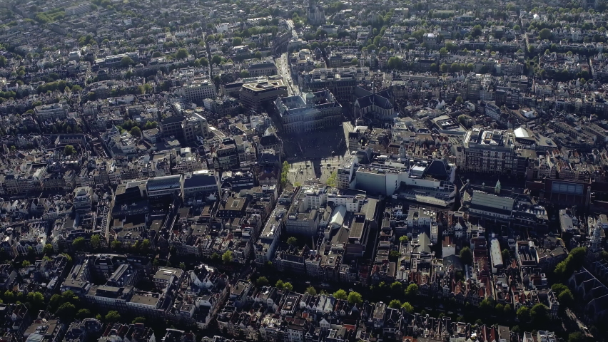Aerial view of Downtown Amsterdam. Dam square and the famous buildings around it. The National Monument, Royal palace and Niece Kerk are some of the many tourist attractions. Netherlands. 