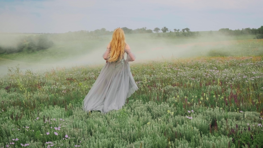 Portrait young happy fantasy blonde woman queen runs walks in green nature whirls dances fluttering skirt gray dress waving in motion. Vintage summer clothes. Candid girl princess bride Back rear view | Shutterstock HD Video #1062950140