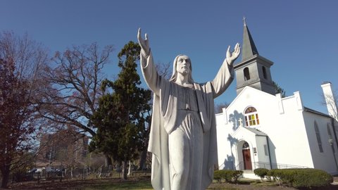 Rockville, Maryland, USA 11.16.2020: Saint Mary's Catholic church complex is the oldest surviving church in Rockville. Panorama shows historic buildings and graveyard as well as a Jesus statue