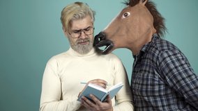Funny Writer Thinker Concept. Funny and Crazy Idea. The Curious Man with Horse Head Mask. Humorous video. Concept Non-standard Situation - Powered by Shutterstock - Get 15% off with code: PIKWIZARD15