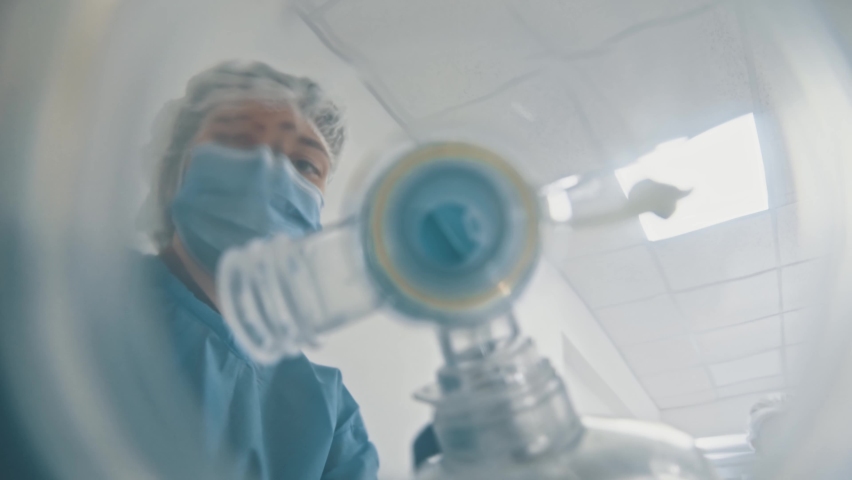 POV shot of patient seeing young doctor or nurse wearing breathing mask on his face hurrying running for emergency department. Motion scene. Close-up. Royalty-Free Stock Footage #1062955669