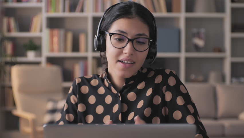 Young middle eastern arabian businesswoman communicate by video call from home,mixed-race confident female speaking looking at computer,online videocall conference distance training office chat