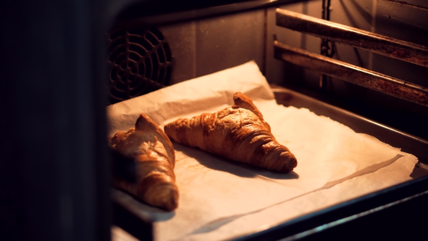 Home Baking Handmade Croissant Dessert On Kitchen Oven. Warm Crispy Baked Croissant Cooked In Oven.Morning Homemade Breakfast Food.Tasty French Croissant On Breakfast.Appetizer Bakery Food Crunch Cake Royalty-Free Stock Footage #1062962728