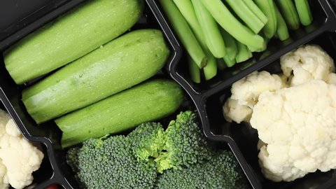 Fresh organic vegetables. Top view of Pumpkin, Broccoli, Bean, Cauliflower vegetables. Slow motion.