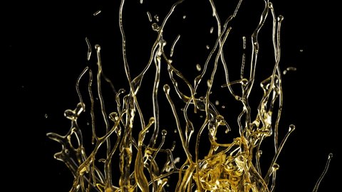 Close-up Oil Splashing and Flowing Isolated on Black Background. Slow Motion Shot of Splash Golden Liquid on Dark Backdrop. Flow Drops of Organic Gold Oil. Colorful Concept of Splash Liquid Oil HDR 4k