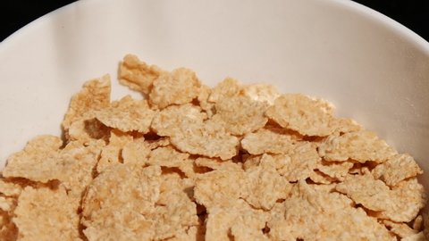 Zoom in motion Time lapse view of Failling cornflakes into a bowl