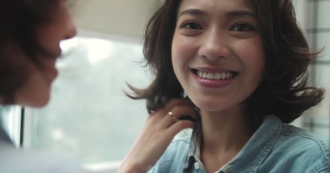 beautiful young smiling girl with short curly hair looking into the mirror confidently with self appreciation and self trust pretty young Asian woman looking at camera smile through 