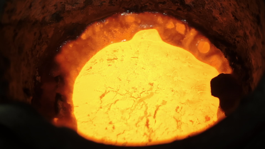 Bright yellow hot liquid gold boils. Factory for the production of precious metals. Industrial oven. Modern plant for the production of non-ferrous metals. Slow motion, Induction oven, Close-up Royalty-Free Stock Footage #1062978652
