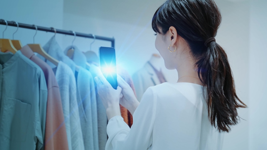 Woman scanning products with a smart phone. Retail as a Service. RaaS. Royalty-Free Stock Footage #1062985234