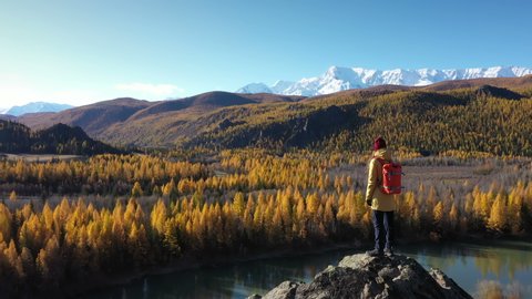 Backpacker Standing on the Rock and Looking at the River Valley in Altai Mountains
