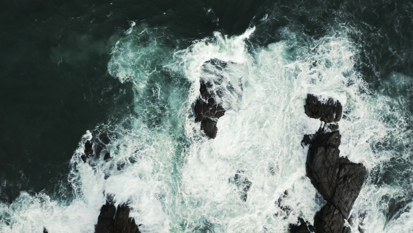 Aerial Drone FLy Up and Rotate over ROcky Beach Bih Waves Crashing int the Beach Cloudly Weather Storm Black Sea | Shutterstock HD Video #1062988105