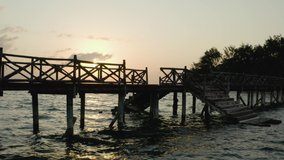 Aerial shot Zanzibar Tanzania. Drone video pier near the island with rocks and trees in the Indian Ocean at sunset with beautiful sky and landscape.